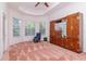 Spacious bedroom with tray ceiling, large window, and built-in wooden storage at 12545 Leatherleaf Dr, Tampa, FL 33626