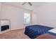 Comfortable bedroom with ceiling fan, large window with blinds, neutral carpet, and closet at 12545 Leatherleaf Dr, Tampa, FL 33626