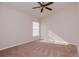 Spacious bedroom with carpet, ceiling fan, and ample natural light from a large window at 12545 Leatherleaf Dr, Tampa, FL 33626