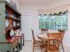 A cozy dining area with a wooden table set and a large window overlooking the screened-in lanai at 12545 Leatherleaf Dr, Tampa, FL 33626