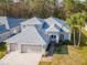 Stunning aerial view of the home, highlighting the well-manicured lawn, and three-car garage at 12545 Leatherleaf Dr, Tampa, FL 33626