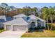 Charming single-Gathering home with a well-manicured lawn, mature trees, and a three-car garage at 12545 Leatherleaf Dr, Tampa, FL 33626