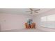 Comfortable living room with a ceiling fan, plush carpet, and large windows offering plenty of natural light at 12545 Leatherleaf Dr, Tampa, FL 33626