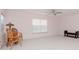 Bright and airy living room with a ceiling fan, plush carpet, and ample seating, creating a welcoming space at 12545 Leatherleaf Dr, Tampa, FL 33626