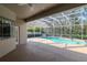 Enclosed pool area, including a sparkling blue pool and covered patio space at 12545 Leatherleaf Dr, Tampa, FL 33626