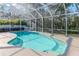 Private screened-in pool surrounded by lush greenery, creating a serene outdoor space at 12545 Leatherleaf Dr, Tampa, FL 33626
