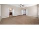 A large primary bedroom featuring neutral walls and carpet with ensuite bathroom and double doors to a closet at 12557 Bassbrook Ln, Tampa, FL 33626