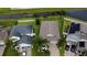 An aerial view of a neighborhood featuring well-maintained homes, lawns and a tranquil lake at 13359 Orca Sound Dr, Riverview, FL 33579