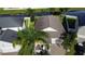Birds eye view of a well-maintained property featuring lush landscaping, a paved driveway and mature trees at 13359 Orca Sound Dr, Riverview, FL 33579