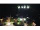 Aerial nighttime view showcases property landscaping, lighting, and neighborhood layout at 13359 Orca Sound Dr, Riverview, FL 33579