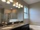 Bathroom boasts double sinks, granite countertops, and a separate shower and tub at 13359 Orca Sound Dr, Riverview, FL 33579
