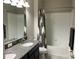 Shot of a bathroom with decorative shower curtain, granite vanity and a white tub at 13359 Orca Sound Dr, Riverview, FL 33579