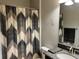 Bathroom featuring decorative shower curtain, gray wall and black and granite vanity at 13359 Orca Sound Dr, Riverview, FL 33579