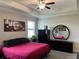 Inviting bedroom with a ceiling fan and large mirror for added comfort and style at 13359 Orca Sound Dr, Riverview, FL 33579