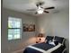 Comfortable bedroom with a ceiling fan, soft carpet, and a window for natural light at 13359 Orca Sound Dr, Riverview, FL 33579