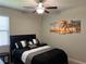 Cozy bedroom featuring a ceiling fan, neutral paint, and decorative art on the wall at 13359 Orca Sound Dr, Riverview, FL 33579
