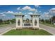 A welcoming community entrance with stone accents, nice landscaping, and manicured grass at 13359 Orca Sound Dr, Riverview, FL 33579