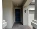 Inviting entryway to the home with dark door, brick pathway, and house number 13359 to the side at 13359 Orca Sound Dr, Riverview, FL 33579