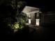 Well-lit home entrance featuring lush landscaping and a welcoming facade at night at 13359 Orca Sound Dr, Riverview, FL 33579