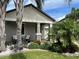 Beautiful home with stone accents and a cozy front porch surrounded by vibrant landscaping and tropical palm trees at 13359 Orca Sound Dr, Riverview, FL 33579