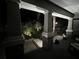 Inviting front porch with stone pillars and a beautifully landscaped front yard at night at 13359 Orca Sound Dr, Riverview, FL 33579