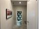 Hallway leading to a bathroom with decorative shower curtain and gray tile flooring at 13359 Orca Sound Dr, Riverview, FL 33579