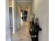 Inviting foyer with decorative console table, showcasing stylish decor and an open view into the modern kitchen at 13359 Orca Sound Dr, Riverview, FL 33579