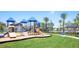 Community playground with slides, climbing features, and a swing set at 13359 Orca Sound Dr, Riverview, FL 33579