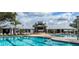 Inviting community pool area featuring a variety of seating, lounging, and umbrellas at 13359 Orca Sound Dr, Riverview, FL 33579