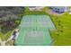Aerial view of community tennis and basketball courts surrounded by lush greenery at 13359 Orca Sound Dr, Riverview, FL 33579