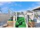 Backyard with above ground pool, astroturf, white fences and exterior storage at 13507 Mango Bay Dr, Riverview, FL 33579