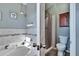 Gray bathroom featuring a shower, garden tub, gray backsplash, and toilet at 13507 Mango Bay Dr, Riverview, FL 33579