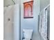 Cozy bathroom featuring gray tile shower, and wooden medicine cabinet above the toilet at 13507 Mango Bay Dr, Riverview, FL 33579