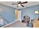 Bedroom featuring light blue walls, a ceiling fan, and hardwood floors at 13507 Mango Bay Dr, Riverview, FL 33579