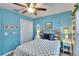 Nautical-themed bedroom featuring blue walls, anchor accents, and a comfortable queen bed at 13507 Mango Bay Dr, Riverview, FL 33579