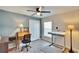 Bedroom with gray plank flooring, ceiling fan, blue accent wall and closet at 13507 Mango Bay Dr, Riverview, FL 33579