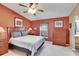 Bedroom featuring warm terra cotta-painted walls and wood furniture at 13507 Mango Bay Dr, Riverview, FL 33579