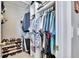 Spacious walk-in closet with ample hanging space, shelving, and shoe storage at 13507 Mango Bay Dr, Riverview, FL 33579