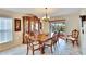 An elegant dining room featuring a beautiful china cabinet and a sliding glass door to the lanai at 13507 Mango Bay Dr, Riverview, FL 33579