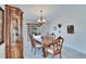 Elegant dining room with a large table, china cabinet, and sliding glass door at 13507 Mango Bay Dr, Riverview, FL 33579