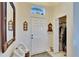 Bright foyer featuring a large mirror, coat closet, and elegant decor at 13507 Mango Bay Dr, Riverview, FL 33579