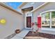 Inviting front entrance with brick walkway, colorful plants and a striking red door at 13507 Mango Bay Dr, Riverview, FL 33579