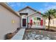 Charming home featuring a well-manicured lawn, a bright red shutter, and a beautiful palm tree at 13507 Mango Bay Dr, Riverview, FL 33579