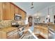 Bright, spacious kitchen featuring modern stainless steel appliances, granite counters, and ample cabinet space at 13507 Mango Bay Dr, Riverview, FL 33579
