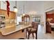 Open kitchen featuring a breakfast bar, granite countertops, and a view into the dining room at 13507 Mango Bay Dr, Riverview, FL 33579