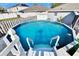 Relaxing backyard pool providing the perfect oasis with white stairs and railings at 13507 Mango Bay Dr, Riverview, FL 33579