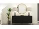 Chic entryway featuring a black console, decor, and a golden round mirror at 13561 Newbridge St, Spring Hill, FL 34609