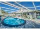 A beautiful caged pool area with patio, pool, enclosure, and adjacent to the home at 1401 Wickham Ln, Holiday, FL 34691