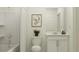 Bright, minimalist bathroom with shower, tub, vanity, and modern fixtures at 15083 Zircon Red Dr, Wimauma, FL 33598