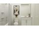 Bright, minimalist bathroom with shower, tub, vanity, and modern fixtures at 15083 Zircon Red Dr, Wimauma, FL 33598